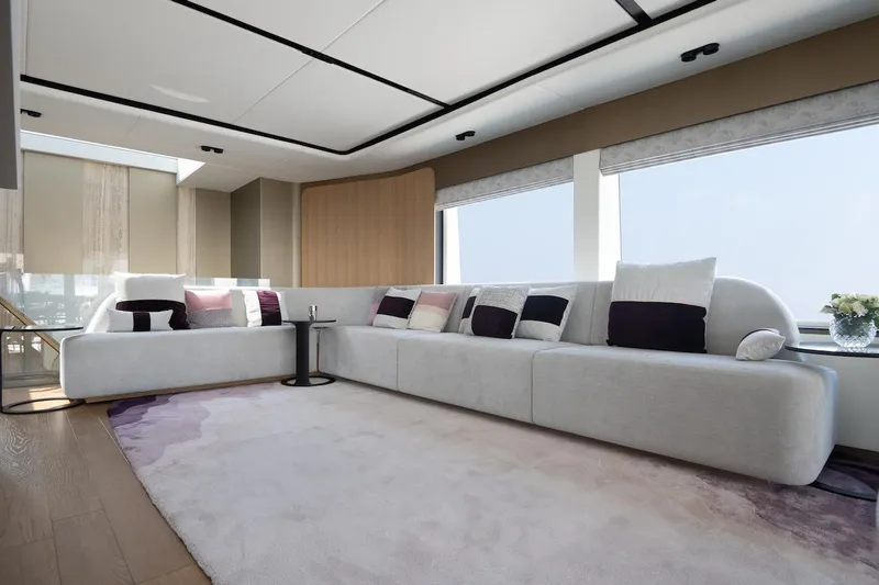 Order To Build Yacht Photos Pics Luxurious yacht interior with modern white sectional sofa, large windows, and elegant decor.