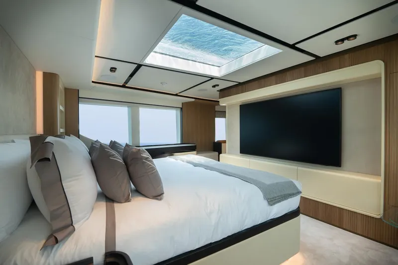 Order To Build Yacht Photos Pics Luxurious bedroom interior of 2026 Majesty 111 yacht with skylight and large TV.