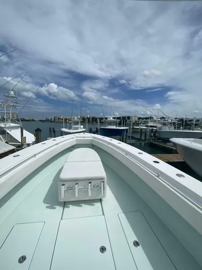 Nauty C Bouys Yacht Photos Pics 2012 Contender 39ST boat docked at marina under cloudy sky.