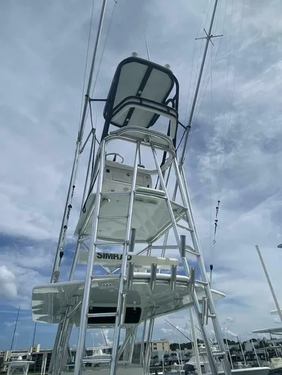 Nauty C Bouys Yacht Photos Pics 2012 Contender 39ST boat tower with multiple levels against a cloudy sky.