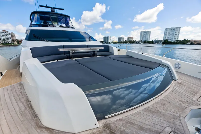 Alter Ego Yacht Photos Pics 2018 Ferretti Yachts 850 Motoryacht deck with luxurious seating, overlooking waterfront skyline.