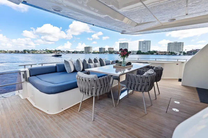 Alter Ego Yacht Photos Pics Luxurious deck of 2018 Ferretti Yachts 850 Motoryacht with elegant seating and scenic water view.