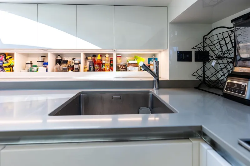 Alter Ego Yacht Photos Pics Modern kitchen in 2018 Ferretti Yachts 850 Motoryacht with sleek countertops and organized shelves.