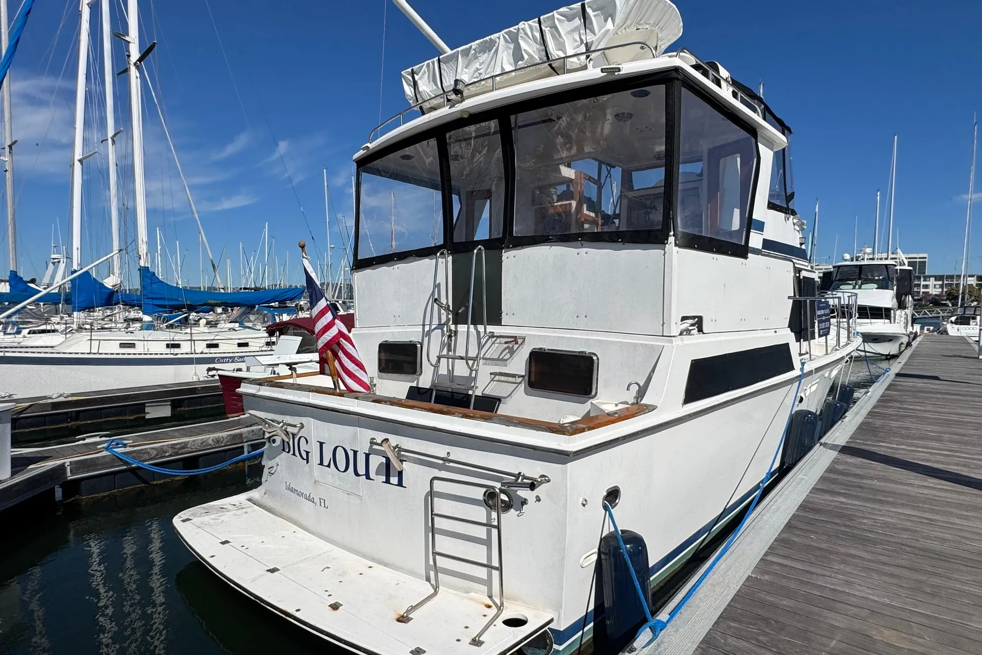 1987 Lien Hwa 47 Cockpit Motor Yacht docked at marina, rear view.