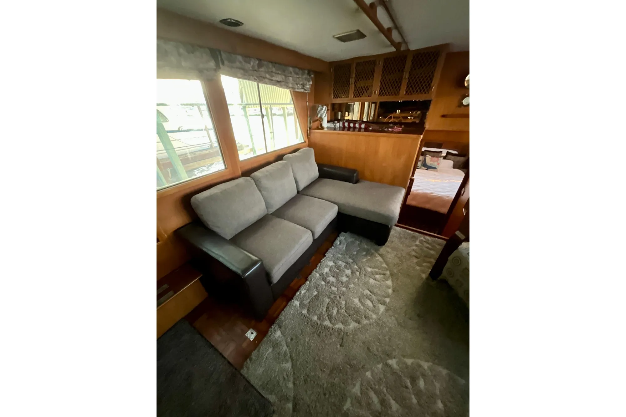 Interior of 1987 Lien Hwa 47 Cockpit Motor Yacht with cozy seating area.