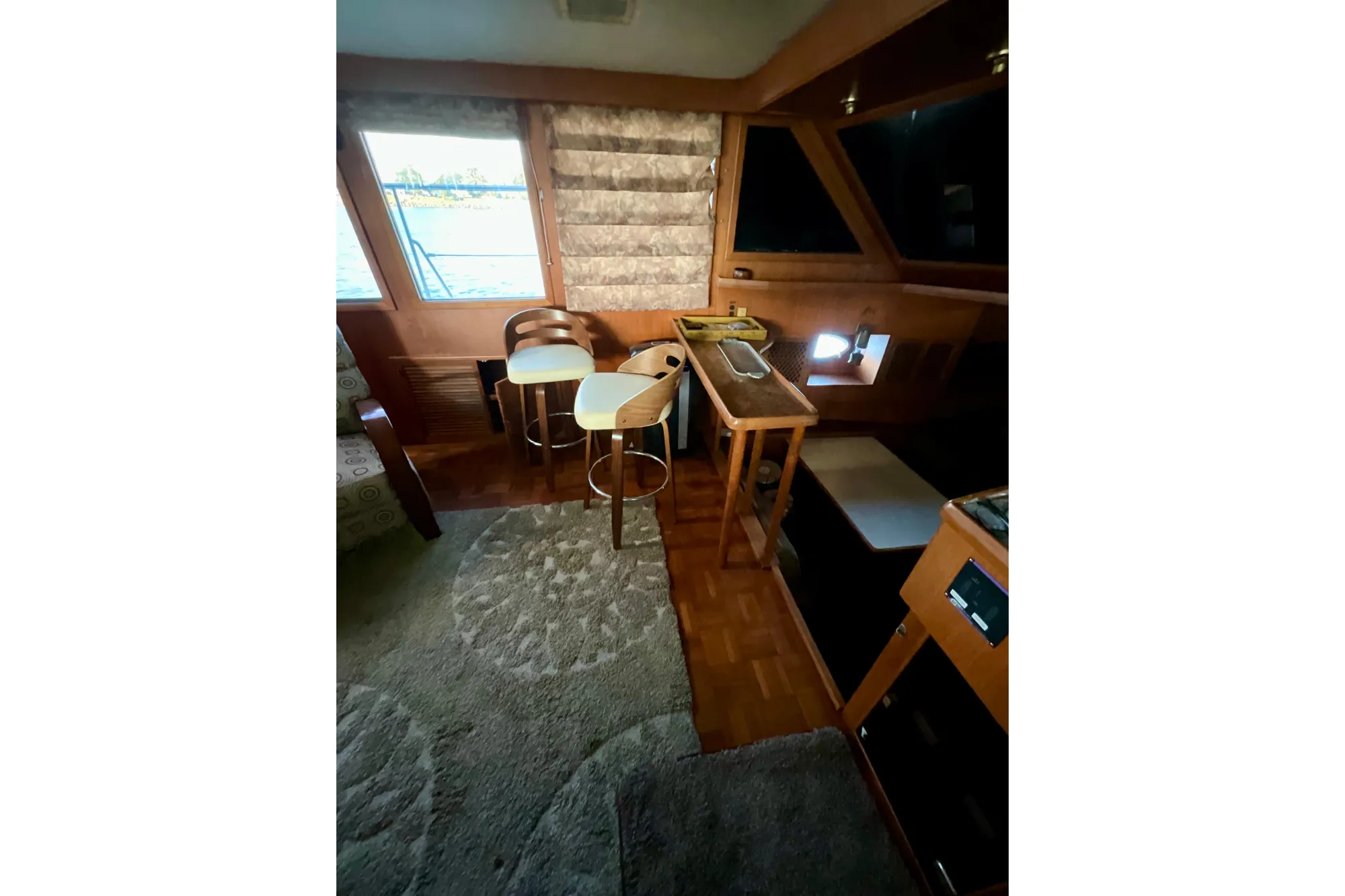 Interior of 1987 Lien Hwa 47 Cockpit Motor Yacht with seating and windows.