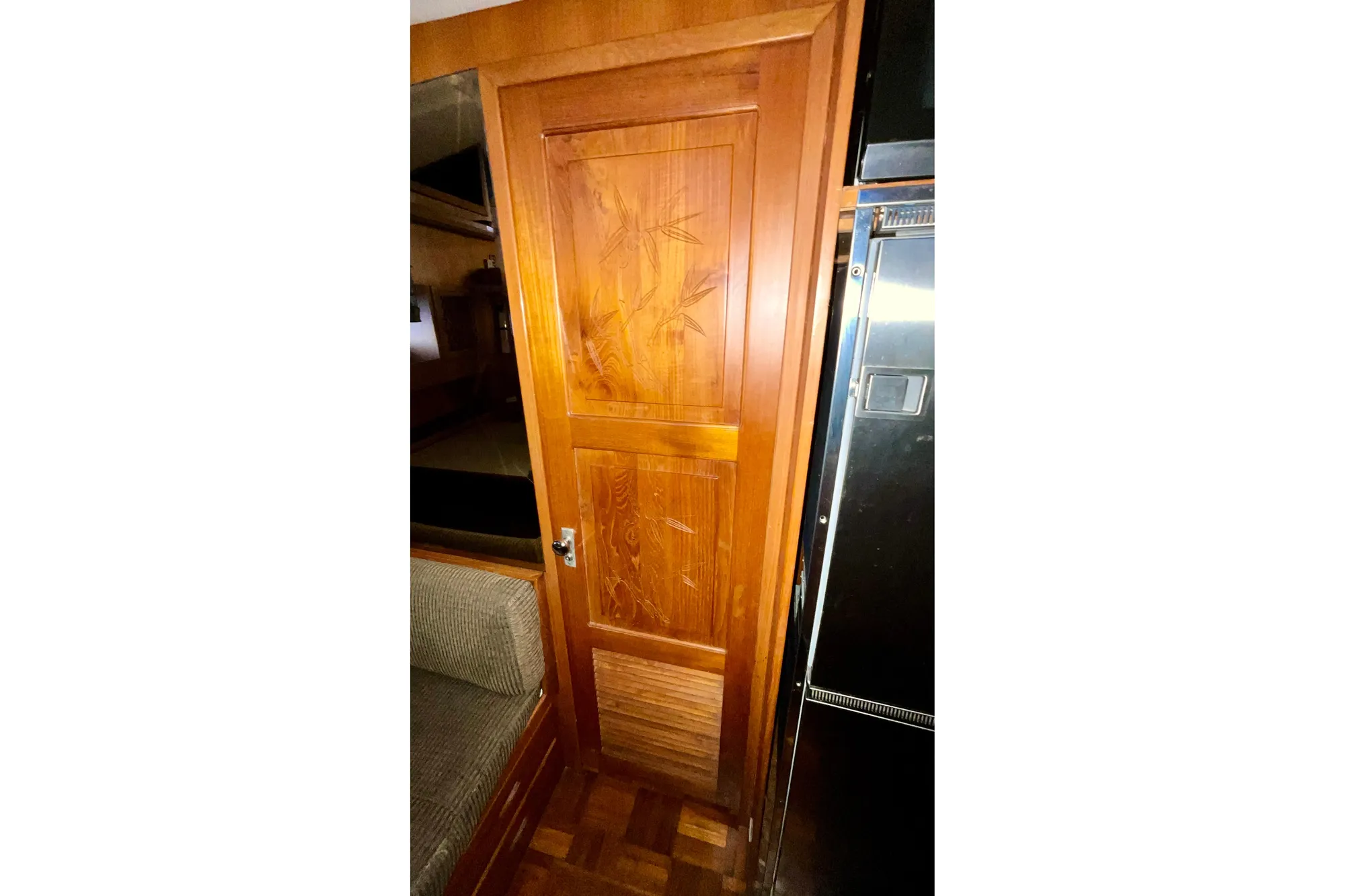 Wooden door with bamboo design inside 1987 Lien Hwa 47 Cockpit Motor Yacht.