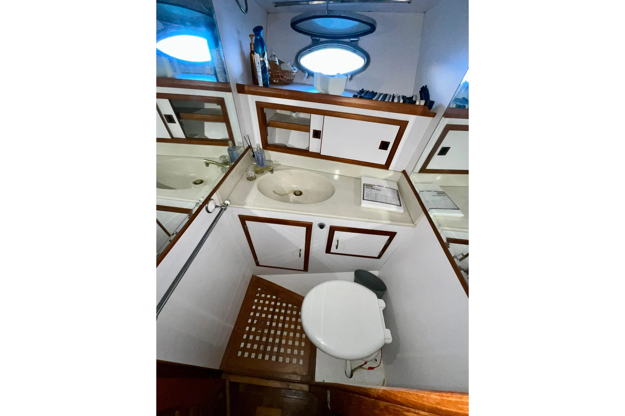 Bathroom interior of 1987 Lien Hwa 47 Cockpit Motor Yacht with sink and toilet.