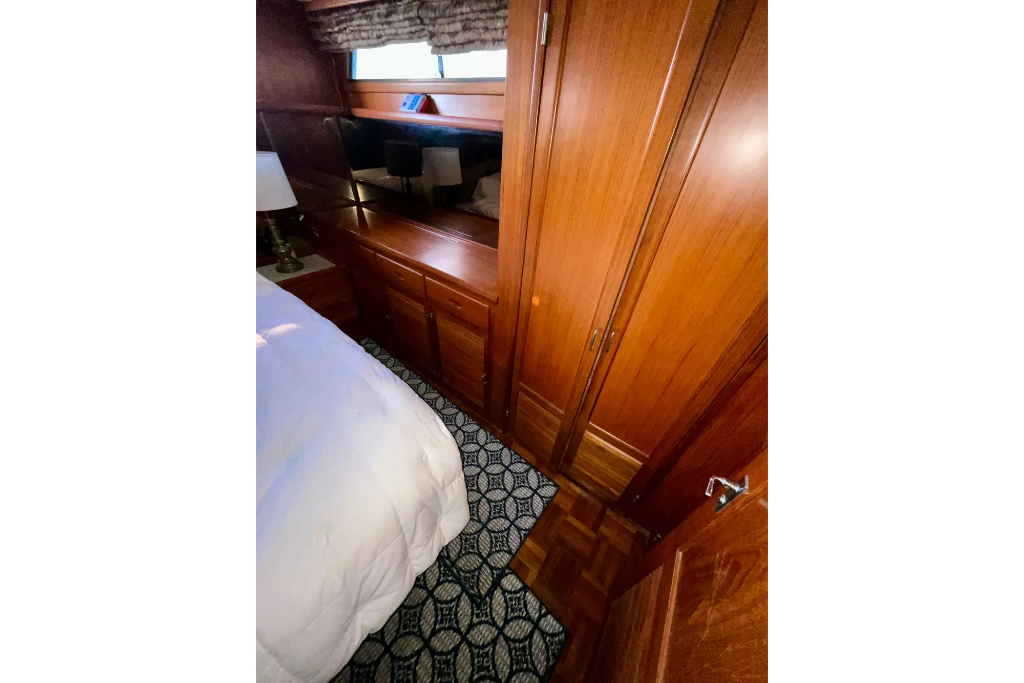 1987 Lien Hwa 47 Cockpit Motor Yacht interior with wood cabinetry and patterned carpet.