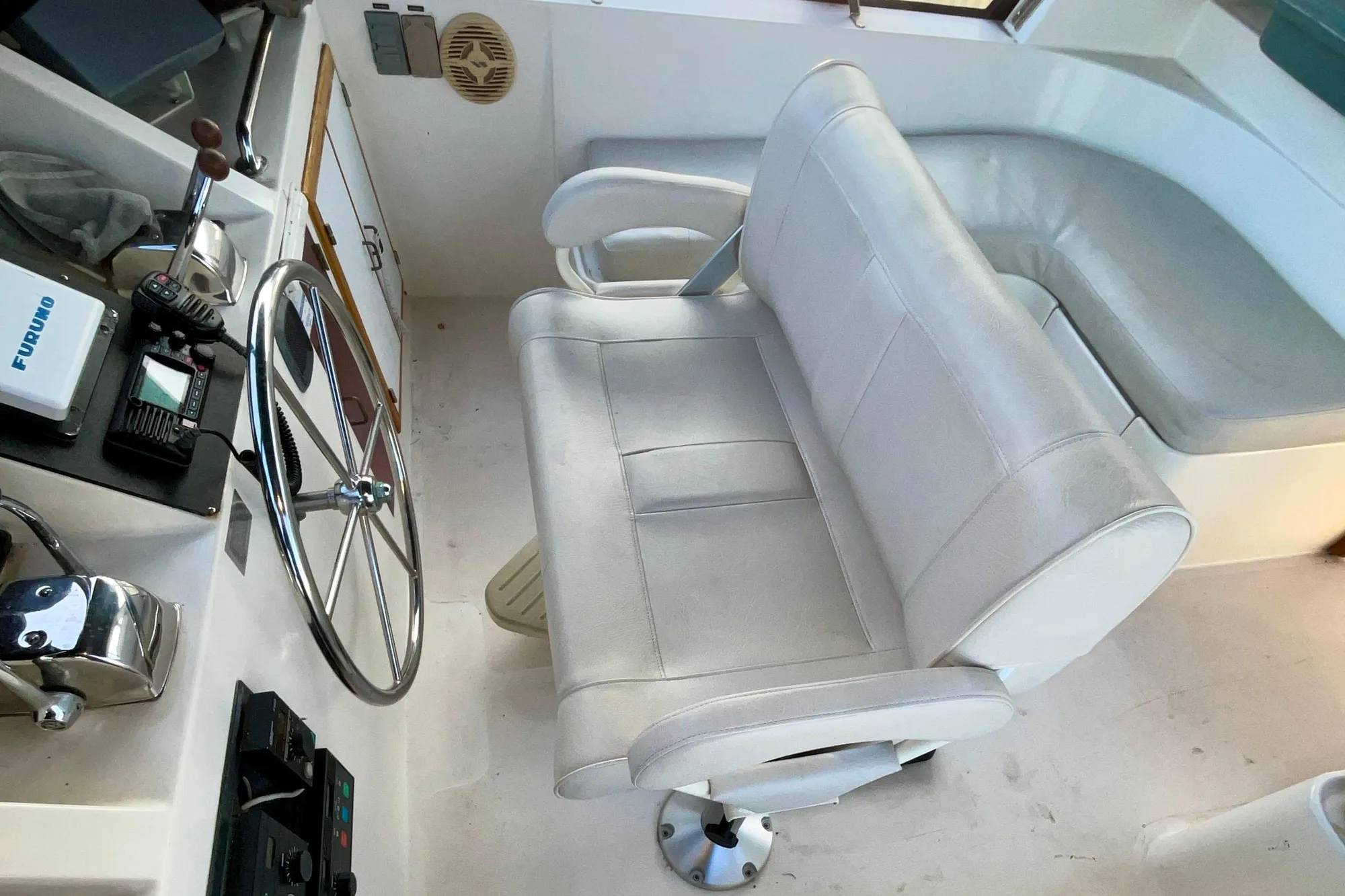 1987 Lien Hwa 47 Cockpit Motor Yacht helm with steering wheel and captain's chair.