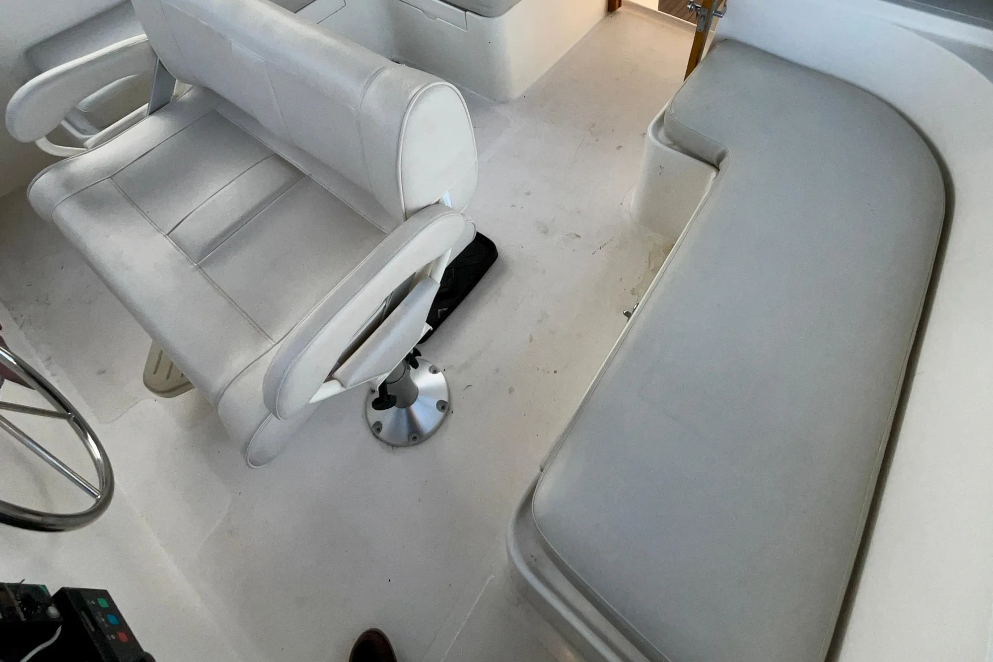 1987 Lien Hwa 47 Cockpit Motor Yacht interior with white seating and helm area.