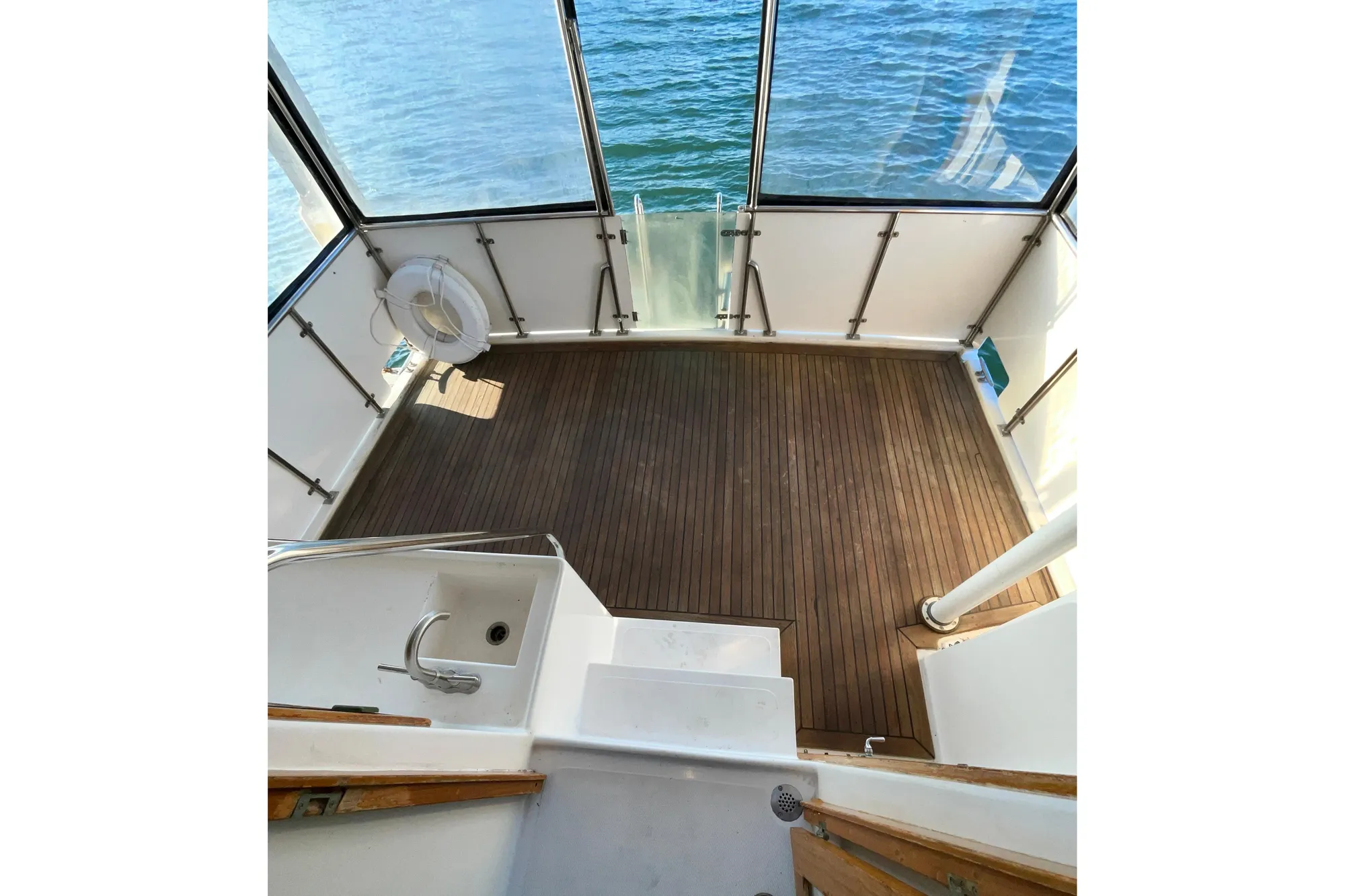 1987 Lien Hwa 47 Cockpit Motor Yacht with wooden deck and ocean view.