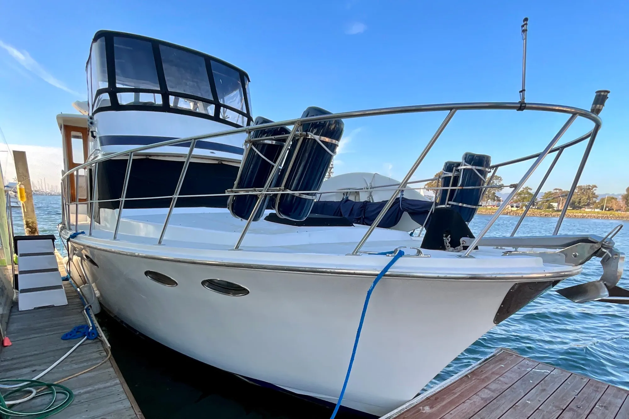 1987 Lien Hwa 47 Cockpit Motor Yacht docked by the water.