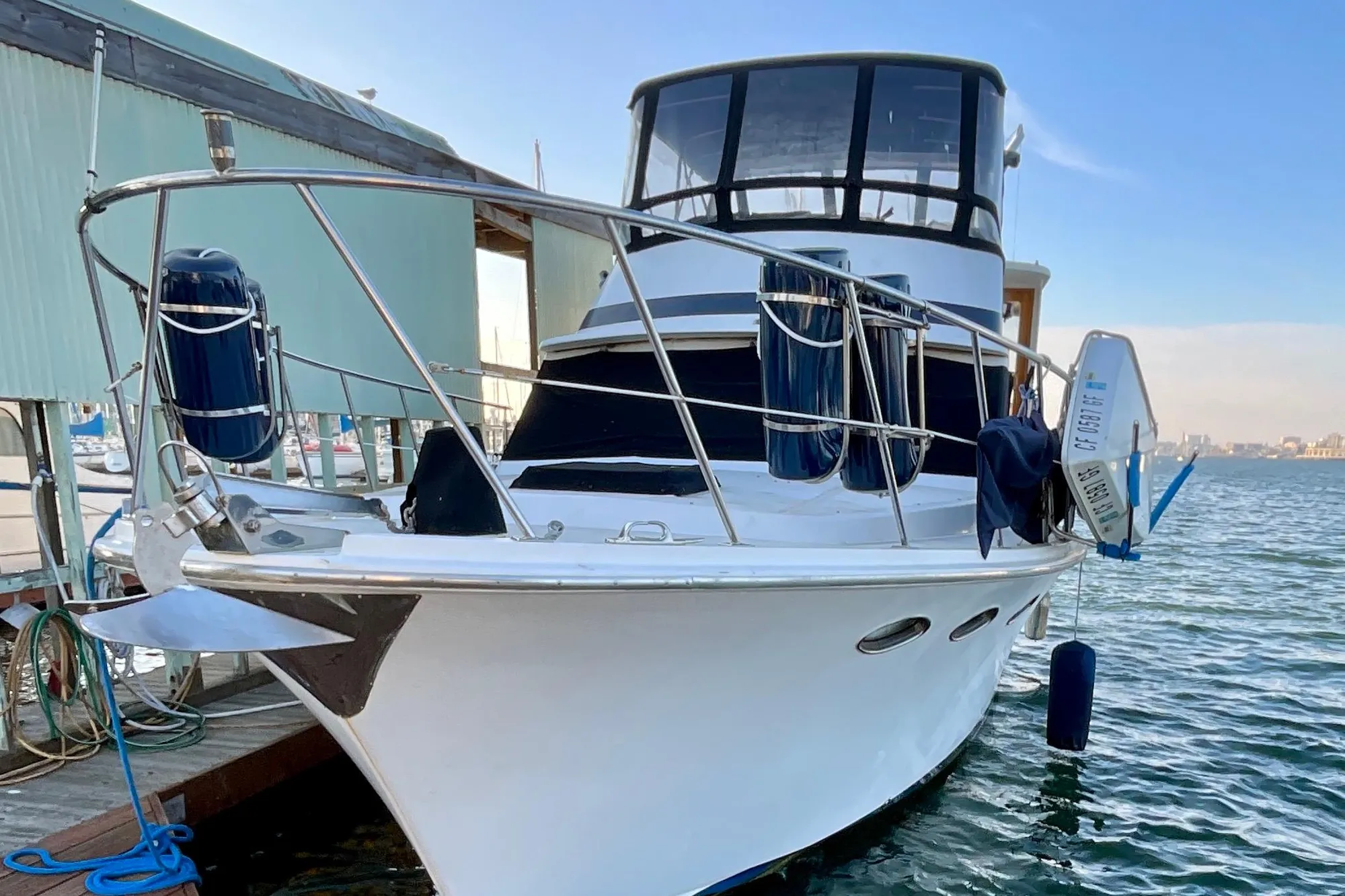 1987 Lien Hwa 47 Cockpit Motor Yacht docked at marina, front view.