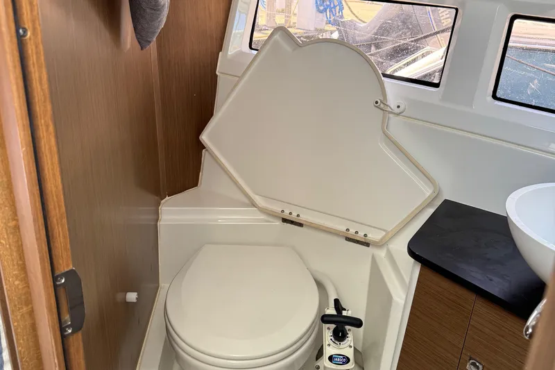 Plumper Yacht Photos Pics 2019 Jeanneau NC 895 boat bathroom with toilet and sink.