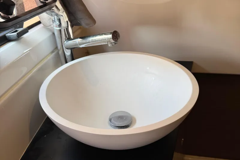 Plumper Yacht Photos Pics White sink with chrome faucet in 2019 Jeanneau NC 895 boat bathroom.