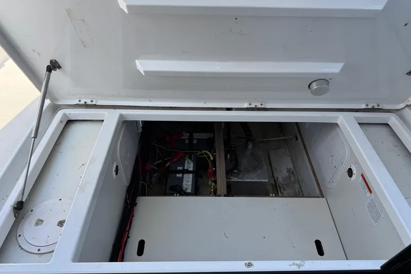 Plumper Yacht Photos Pics Open engine compartment of 2019 Jeanneau NC 895 boat, showing battery and wiring.