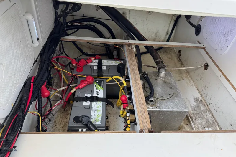 Plumper Yacht Photos Pics 2019 Jeanneau NC 895 boat battery compartment with wiring and metal tank.