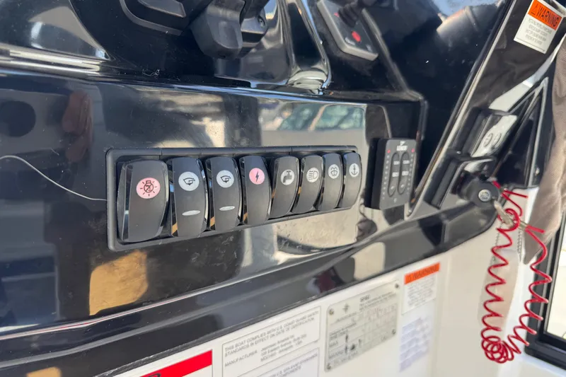 Plumper Yacht Photos Pics Control panel of a 2019 Jeanneau NC 895 boat with various switches and labels.