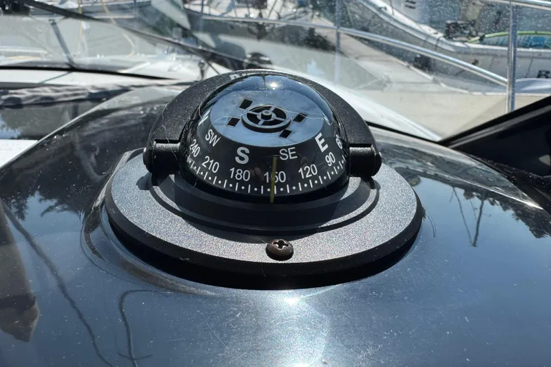 Plumper Yacht Photos Pics Compass on 2019 Jeanneau NC 895 boat, showing south direction.