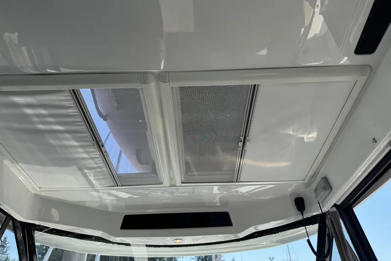 Plumper Yacht Photos Pics Interior view of 2019 Jeanneau NC 895 boat's sunroof and ceiling design.
