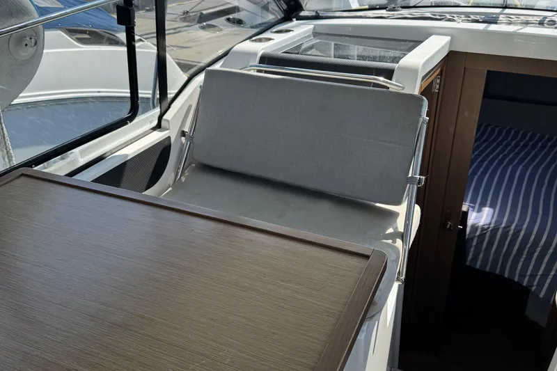 Plumper Yacht Photos Pics 2019 Jeanneau NC 895 interior with seating, table, and cabin view.