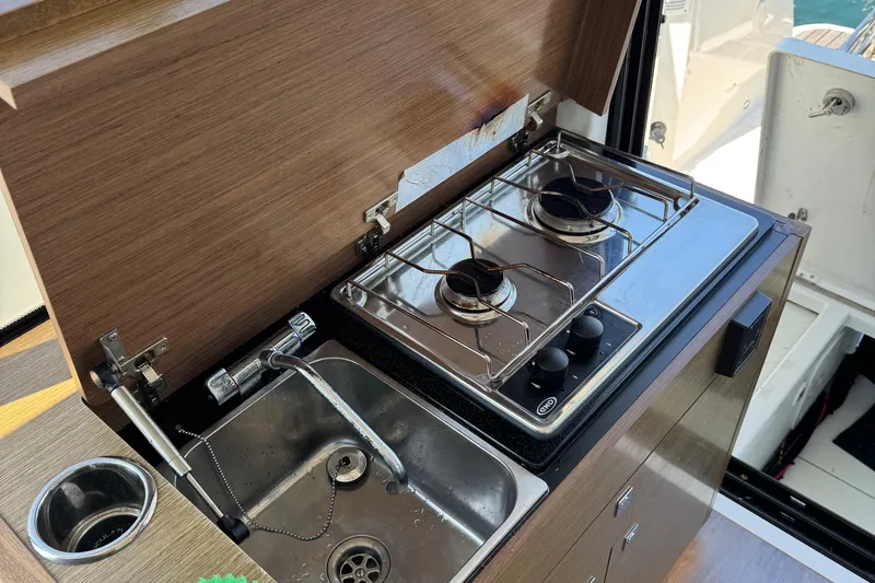 Plumper Yacht Photos Pics Compact kitchen area in 2019 Jeanneau NC 895 boat with stove and sink.