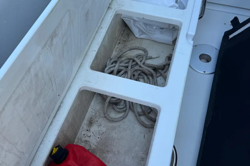 Plumper Yacht Photos Pics Storage compartment on 2019 Jeanneau NC 895 boat with rope and red container.