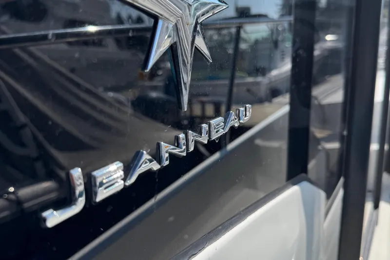 Plumper Yacht Photos Pics Close-up of Jeanneau NC 895 boat logo, 2019 model, with reflective surface.