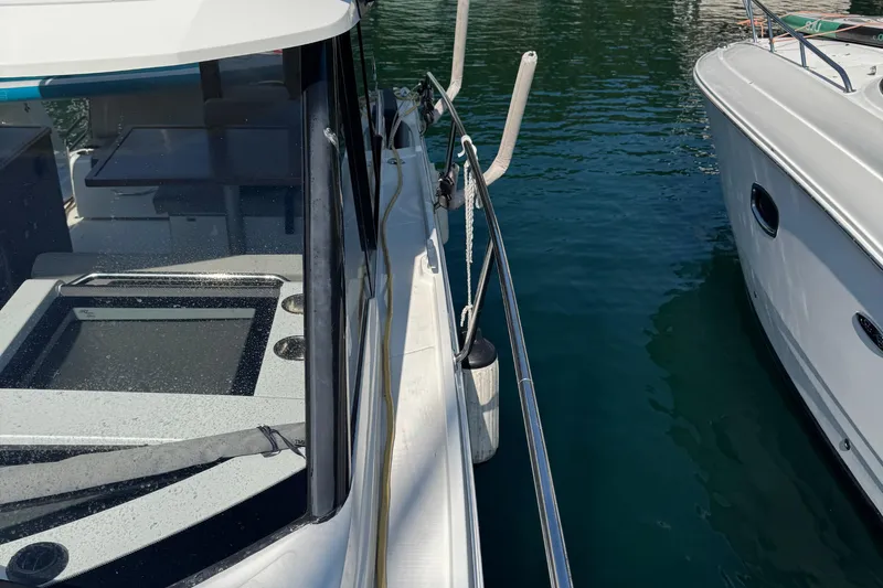 Plumper Yacht Photos Pics 2019 Jeanneau NC 895 boat docked, showing deck and water reflection.