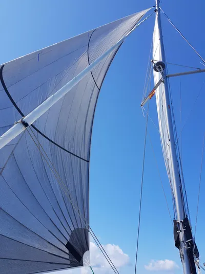 Kaya Yacht Photos Pics Sails of a 2021 Lagoon 42 catamaran against a clear blue sky.