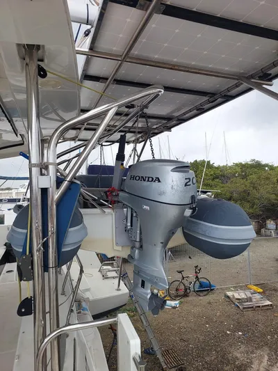 Kaya Yacht Photos Pics Lagoon 42 catamaran with Honda outboard motor, solar panels, and docked at a marina.