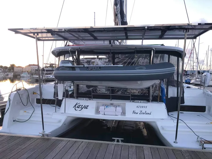 Kaya Yacht Photos Pics 2021 Lagoon 42 catamaran docked, featuring a dinghy and solar panels, New Zealand registration.