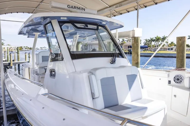  Yacht Photos Pics 2023 Pursuit S 328 Sport boat docked, featuring sleek design and modern amenities.