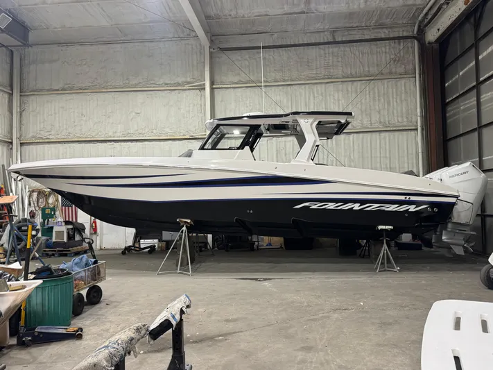  Yacht Photos Pics 2025 Fountain 38 SCX boat in a warehouse, side view.