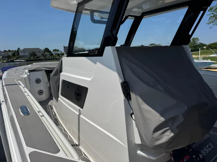  Yacht Photos Pics 2025 Fountain 38 SCX boat, sleek design, docked with covered seating area.