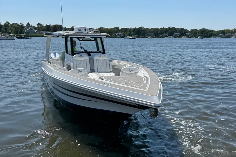 Yacht Photos Pics 2025 Fountain 38 SCX boat on calm water, showcasing sleek design and modern features.