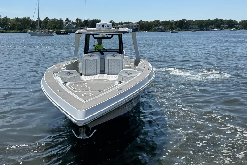  Yacht Photos Pics 2025 Fountain 38 SCX boat on calm water, showcasing sleek design and modern features.