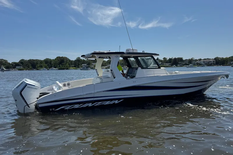  Yacht Photos Pics 2025 Fountain 38 SCX boat on calm water, featuring sleek design and powerful Mercury engine.
