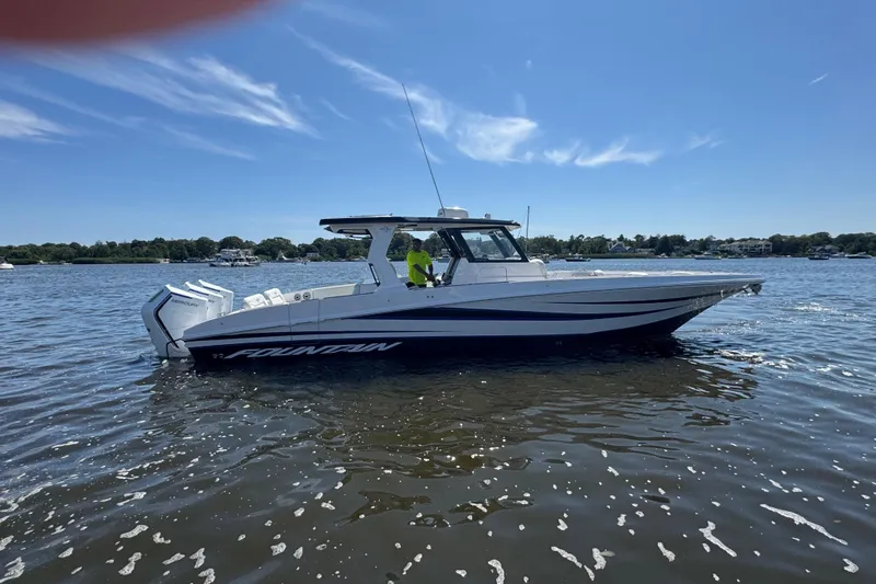  Yacht Photos Pics 2025 Fountain 38 SCX boat on calm water under clear blue sky.