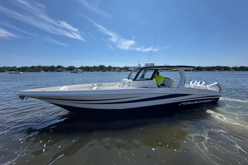  Yacht Photos Pics 2025 Fountain 38 SCX boat cruising on a sunny day, showcasing sleek design and performance.