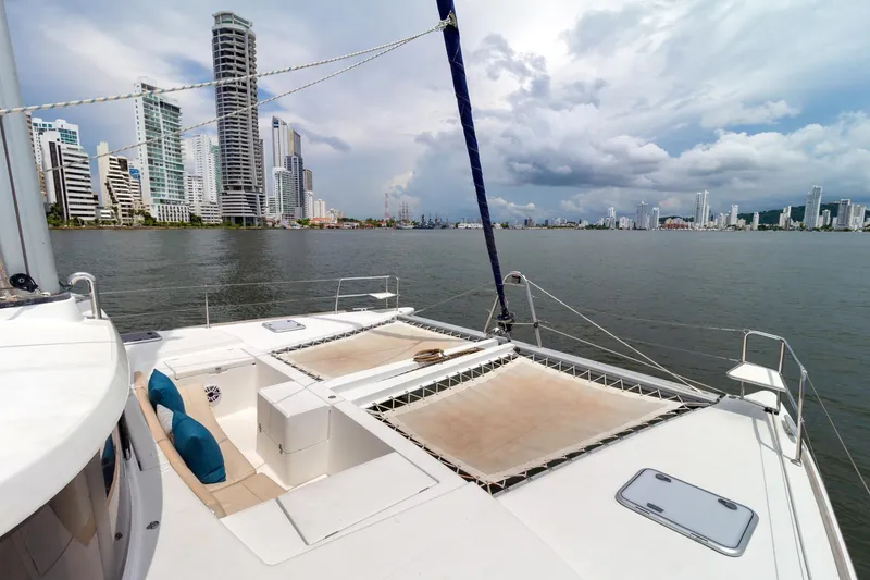 Agm26a09z3354 Yacht Photos Pics Lagoon 440 catamaran sailing near city skyline, cloudy sky, 2010 model.