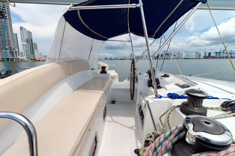 Agm26a09z3354 Yacht Photos Pics Lagoon 440 catamaran cockpit with city skyline view, featuring seating and sailing equipment.