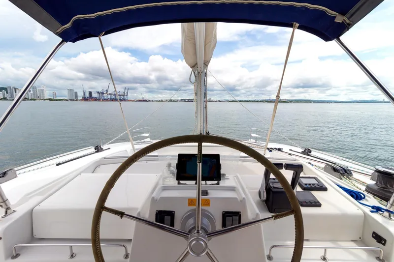 Agm26a09z3354 Yacht Photos Pics Cockpit view of 2010 Lagoon 440 catamaran with steering wheel and ocean backdrop.