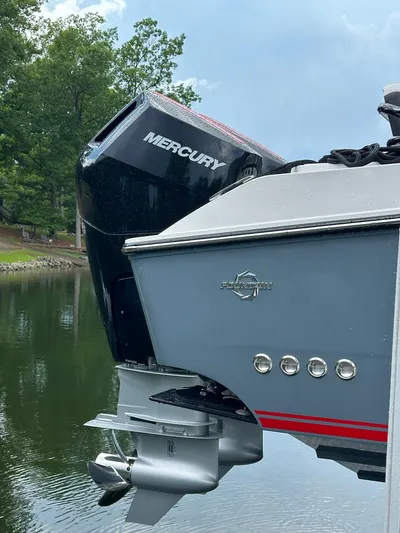  Yacht Photos Pics 2024 Fountain 32 NX boat with Mercury outboard motor on a calm lake.