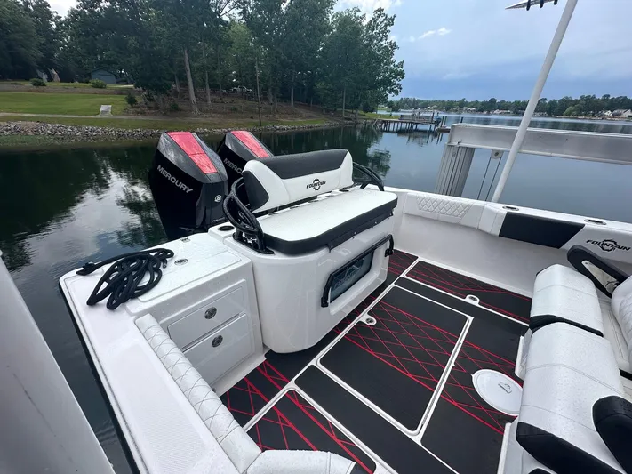  Yacht Photos Pics 2024 Fountain 32 NX boat interior with seating and dual Mercury engines.