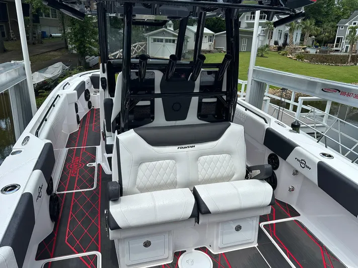  Yacht Photos Pics 2024 Fountain 32 NX boat interior with white seating and modern design.