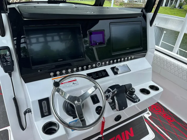  Yacht Photos Pics 2024 Fountain 32 NX boat dashboard with dual screens and steering wheel.