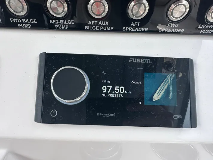  Yacht Photos Pics Control panel of a 2024 Fountain 32 NX boat with radio display at 97.50 MHz.