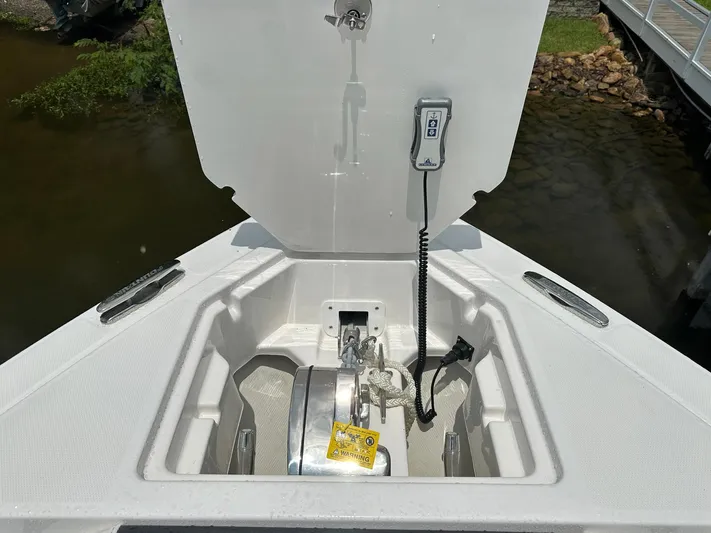  Yacht Photos Pics 2024 Fountain 32 NX boat anchor compartment with control panel, open hatch, and water view.